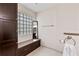 Main bathroom with glass block window, storage cabinet, a vanity bench with storage at 6 Leisure Wood Way, Ormond Beach, FL 32174