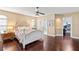 Well lit main bedroom featuring hardwood floors, ceiling fan, and ensuite bathroom at 6 Leisure Wood Way, Ormond Beach, FL 32174