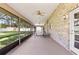 A well-lit screened patio with ping pong table at 6 Leisure Wood Way, Ormond Beach, FL 32174
