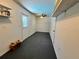 Unfinished basement with a ceiling fan and exterior access door at 600 S Parkview Ave, Orange City, FL 32763