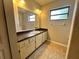 Neutral-toned bathroom featuring vanity with ample storage and a large mirror at 600 S Parkview Ave, Orange City, FL 32763