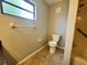 Bathroom featuring a toilet, shower/bath combo, and a window for natural light at 600 S Parkview Ave, Orange City, FL 32763