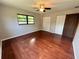 This bedroom is illuminated by natural light, hardwood floors and has a ceiling fan at 600 S Parkview Ave, Orange City, FL 32763