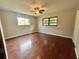 This bedroom is illuminated by natural light, hardwood floors and has a ceiling fan at 600 S Parkview Ave, Orange City, FL 32763