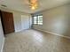 This bedroom is illuminated by natural light and has large tile flooring and a ceiling fan at 600 S Parkview Ave, Orange City, FL 32763