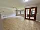 This spacious living room is illuminated by natural light and has large tile flooring and a ceiling fan at 600 S Parkview Ave, Orange City, FL 32763