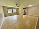 This spacious living room is illuminated by natural light and has large tile flooring and a ceiling fan at 600 S Parkview Ave, Orange City, FL 32763
