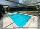 Screened-in pool area with a hot tub and mature trees in the background at 600 S Parkview Ave, Orange City, FL 32763