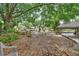 Large backyard with mature trees and a covered patio provides a private outdoor space at 601 N Garfield Ave, Deland, FL 32724