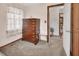 Bedroom featuring carpeting, a dresser, and access to the rest of the home at 601 N Garfield Ave, Deland, FL 32724