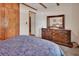Bedroom with a wooden dresser and doorway leading to the ensuite bathroom at 601 N Garfield Ave, Deland, FL 32724
