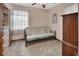 Spare bedroom with a futon and a view out of the window with curtains at 601 N Garfield Ave, Deland, FL 32724