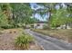Charming home surrounded by mature trees and lush landscaping with a long driveway at 601 N Garfield Ave, Deland, FL 32724