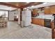 Spacious kitchen with tile floors, wood cabinets, and views of the living spaces at 601 N Garfield Ave, Deland, FL 32724
