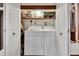 Bright laundry room features a washer and dryer, along with ample shelving space for storage at 601 N Garfield Ave, Deland, FL 32724