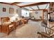 Comfortable living room with wood beam ceilings, a brick fireplace, and neutral carpet at 601 N Garfield Ave, Deland, FL 32724