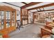 Cozy living room with wooden beams, a brick fireplace, and built-in display cabinets at 601 N Garfield Ave, Deland, FL 32724