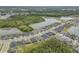 A picturesque aerial view of a community with multiple ponds, well-manicured lawns, and modern homes at 660 Mosaic Blvd, Daytona Beach, FL 32124