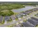 Aerial view showcasing modern homes near a serene lake and lush green landscape at 660 Mosaic Blvd, Daytona Beach, FL 32124