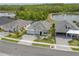 Aerial view of a home with a paver driveway near a serene lake at 660 Mosaic Blvd, Daytona Beach, FL 32124