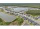 Stunning aerial view of a residential community surrounding a large lake, with lush greenery and modern homes at 660 Mosaic Blvd, Daytona Beach, FL 32124