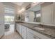 Elegant bathroom featuring a granite countertop, dual sinks, and ample storage at 660 Mosaic Blvd, Daytona Beach, FL 32124