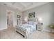 Bright bedroom featuring coastal-themed decor, a decorative quilt, and access to the ensuite bathroom at 660 Mosaic Blvd, Daytona Beach, FL 32124