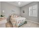 Cozy bedroom with seashell bedding, white furnishings, and shuttered windows at 660 Mosaic Blvd, Daytona Beach, FL 32124