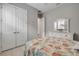 Serene bedroom with neutral walls, seashell bedding, white dresser, and double closets at 660 Mosaic Blvd, Daytona Beach, FL 32124