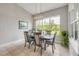 This dining room features a modern light fixture and views of the landscaped outdoors at 660 Mosaic Blvd, Daytona Beach, FL 32124