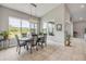 Bright dining room features a modern light fixture, large windows, and serene water views at 660 Mosaic Blvd, Daytona Beach, FL 32124