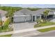 Beautiful exterior featuring a manicured lawn and a three-car garage at 660 Mosaic Blvd, Daytona Beach, FL 32124