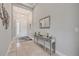 Elegant foyer featuring tiled floor, decorative lighting, console table, and a decorative mirror at 660 Mosaic Blvd, Daytona Beach, FL 32124