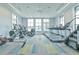 Bright gym provides treadmills, ellipticals, and other fitness equipment with natural light and ceiling fans at 660 Mosaic Blvd, Daytona Beach, FL 32124