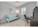 Functional home office with a futon, modern desk, and bright window at 660 Mosaic Blvd, Daytona Beach, FL 32124