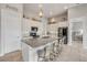 A spacious kitchen features granite countertops, stainless steel appliances, and an island with barstool seating at 660 Mosaic Blvd, Daytona Beach, FL 32124