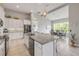 Modern kitchen and dining area with stainless steel appliances, granite countertops, and a beautiful view of the backyard at 660 Mosaic Blvd, Daytona Beach, FL 32124