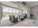 Relaxing outdoor lanai with screened enclosure, comfortable seating, and a scenic view of the lake at 660 Mosaic Blvd, Daytona Beach, FL 32124