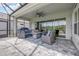 Covered lanai with outdoor seating, ceiling fan, screened enclosure, and a view of the backyard and lake at 660 Mosaic Blvd, Daytona Beach, FL 32124