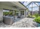 A view of the covered lanai includes outdoor seating, ceiling fan, a screened enclosure, and access to the backyard at 660 Mosaic Blvd, Daytona Beach, FL 32124