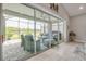 The screened lanai features sliding glass doors, comfortable seating, and views of the backyard and lake at 660 Mosaic Blvd, Daytona Beach, FL 32124