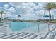 Community pool with zero entry access, metal handrails, lounge seating, and palm trees at 660 Mosaic Blvd, Daytona Beach, FL 32124