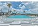 Community pool with zero entry access, metal handrails, lounge seating, and palm trees at 660 Mosaic Blvd, Daytona Beach, FL 32124