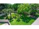 Lush backyard featuring mature trees, a fire pit, and a charming pergola, creating a serene outdoor oasis at 68 Spring Lake Dr, Debary, FL 32713
