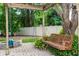 Brick patio with a cozy swing and a charming bench, perfect for relaxing in the serene outdoor space at 68 Spring Lake Dr, Debary, FL 32713