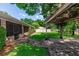 Landscaped backyard with a covered patio, brick pavers, and a screened porch on a charming single-Gathering home at 68 Spring Lake Dr, Debary, FL 32713