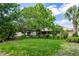 Expansive backyard with a covered patio and privacy fence offers a serene outdoor space for relaxation and entertainment at 68 Spring Lake Dr, Debary, FL 32713
