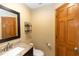 This bathroom is equipped with a granite vanity, toilet, and warm wooden accents at 68 Spring Lake Dr, Debary, FL 32713