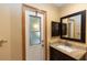 Bathroom featuring a granite vanity and access door with frosted glass for privacy at 68 Spring Lake Dr, Debary, FL 32713