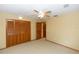 This carpeted bedroom features a ceiling fan and closet with paneled doors at 68 Spring Lake Dr, Debary, FL 32713